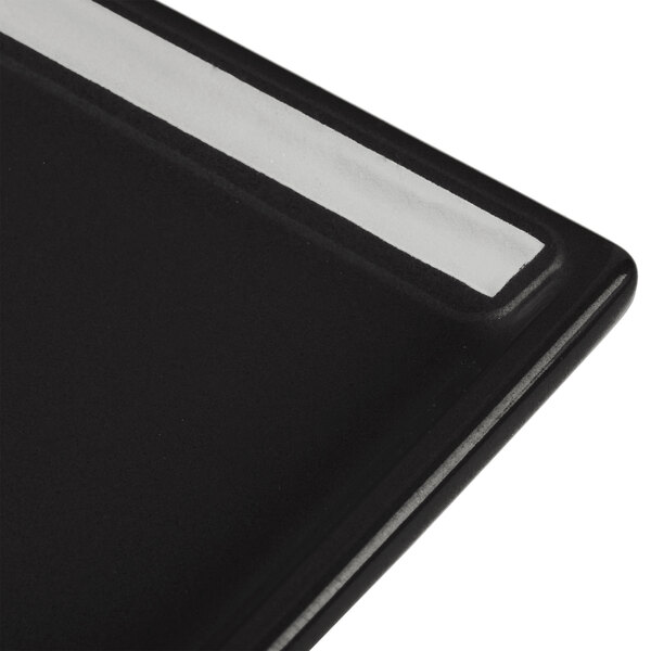A close-up of a black rectangular Tablecraft cooling platter.
