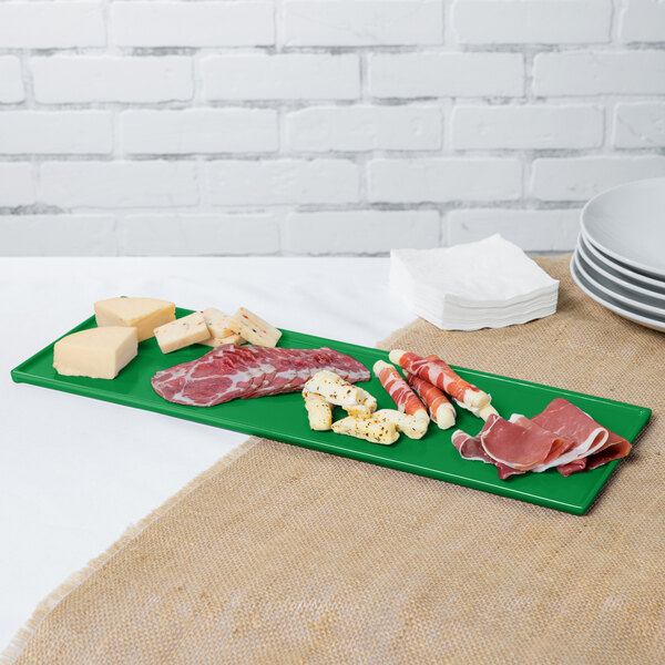 A green Tablecraft rectangular cast aluminum tray with meat and cheese on it.