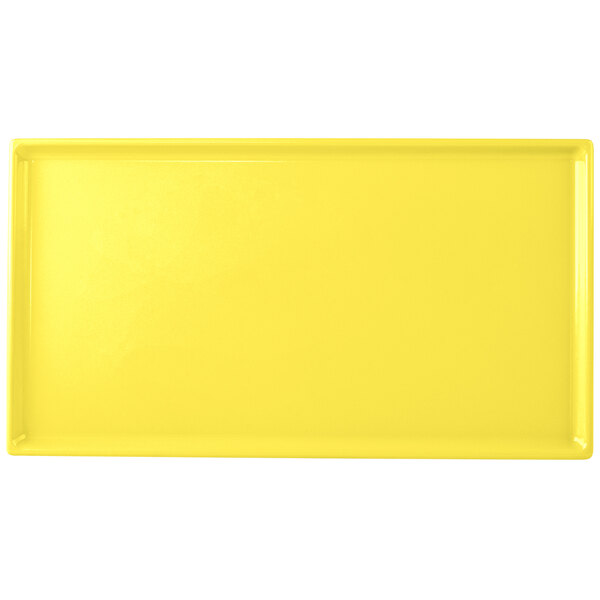 A yellow rectangular cast aluminum Tablecraft cooling platter.