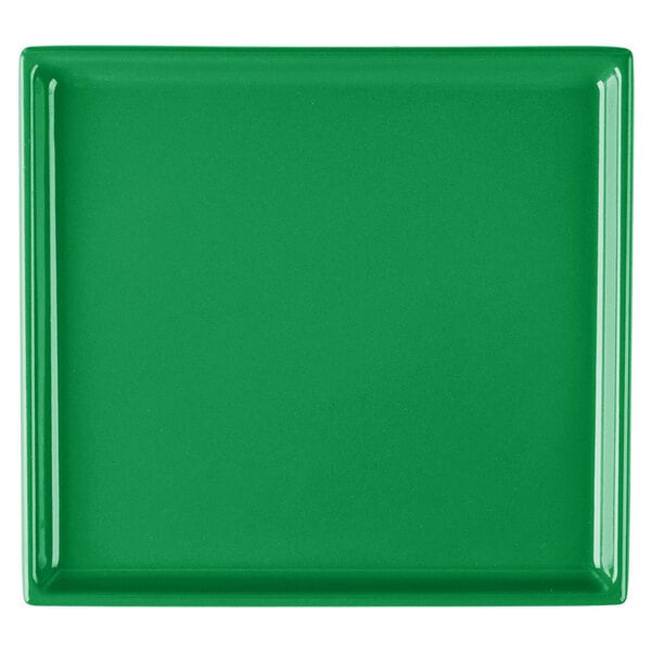 A green rectangular cast aluminum cooling platter on a white surface.