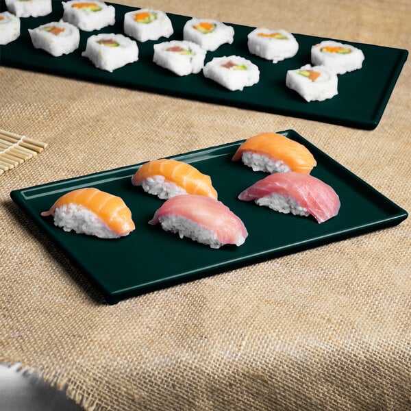 A Tablecraft hunter green with white speckle rectangular cooling platter with sushi on a table.