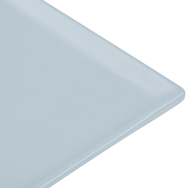 A close-up of a gray Tablecraft cast aluminum rectangular cooling platter.