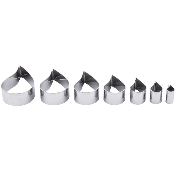 A silver metal Ateco cookie cutter set with a row of six comma-shaped cutters.