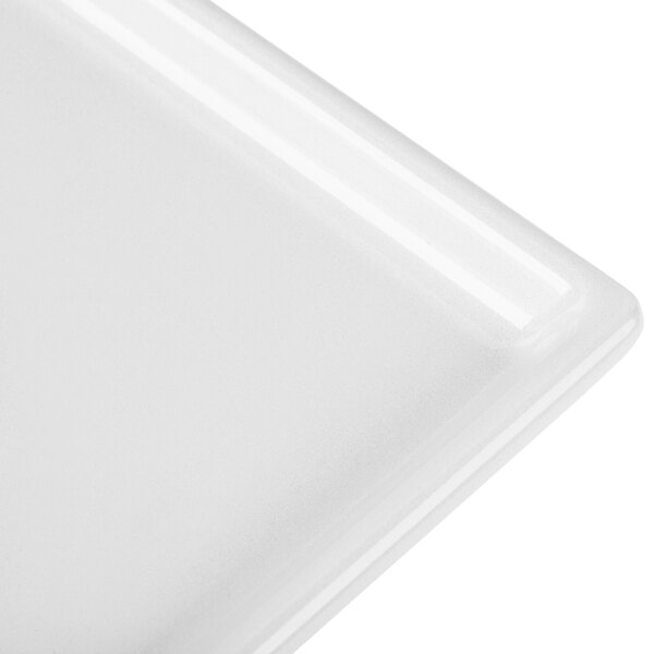 A close-up of a white Tablecraft cast aluminum rectangular cooling platter.