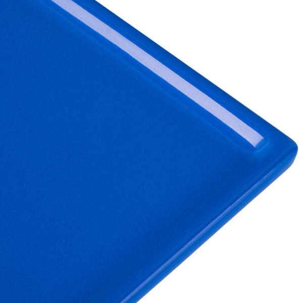 A close-up of a Tablecraft cobalt blue cast aluminum rectangular cooling platter.