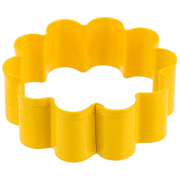 A yellow metal flower-shaped cookie cutter.