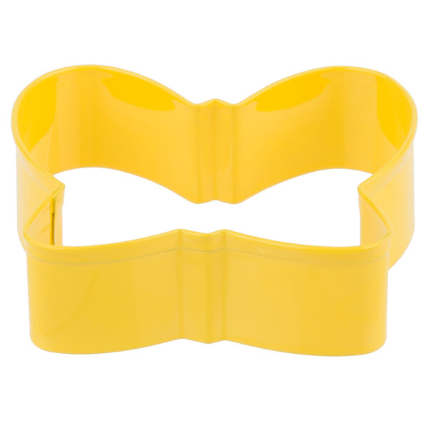 A yellow metal butterfly cookie cutter with two handles.