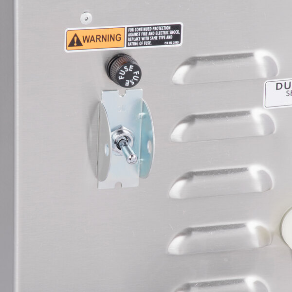 A close up of the metal box on a Curtis G4CBHS combination tea and coffee brewer.