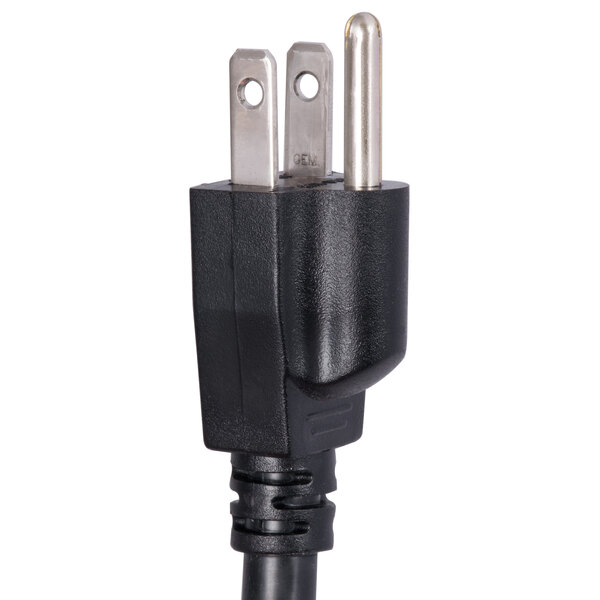 A black power cord with two plugs on it plugged into a Curtis combination tea and coffee brewer.