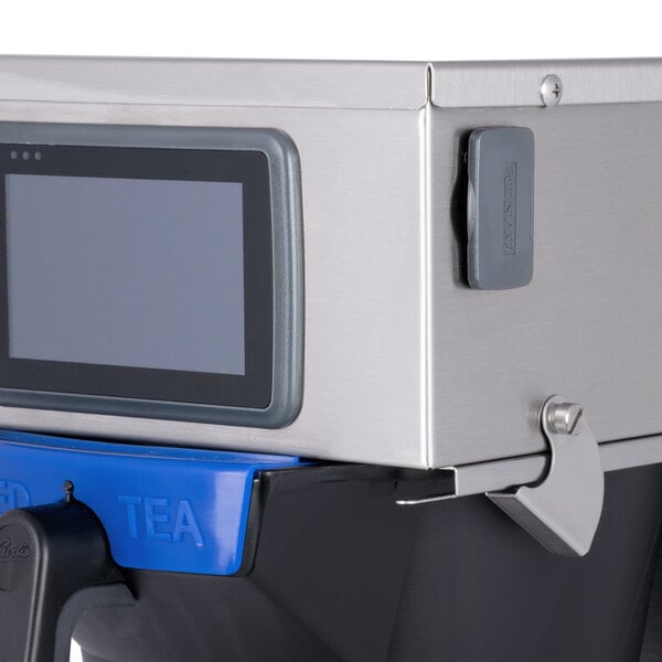 A Curtis tea brewer with a blue screen and silver handle.