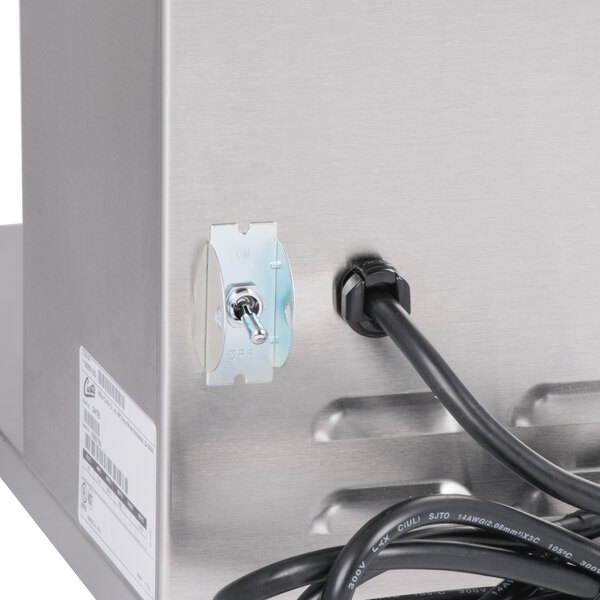 A close-up of a Curtis 3-5 gallon tea brewer with a power cord attached.