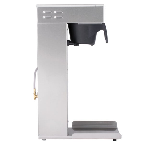 A silver Curtis tea brewer with a black rotating brew basket.