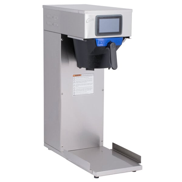 A Curtis low profile tea brewer with a blue screen and silver base.