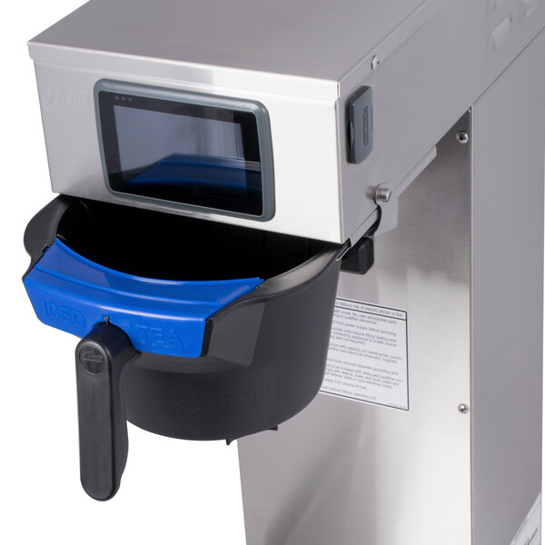 A Curtis low profile tea brewer with a black container and blue lid.
