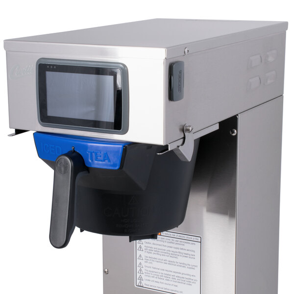 A Curtis low profile tea brewer with black buttons and a blue handle.