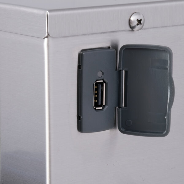 A close-up of a Curtis low profile tea brewer with a USB port.