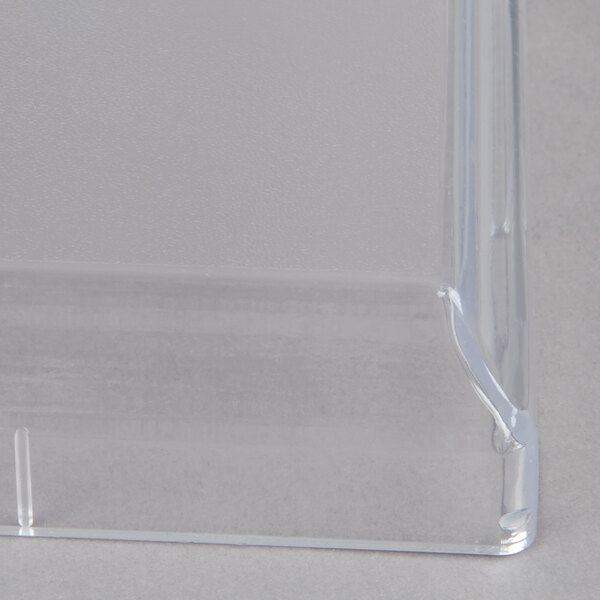 A clear plastic lid with a hole in it.