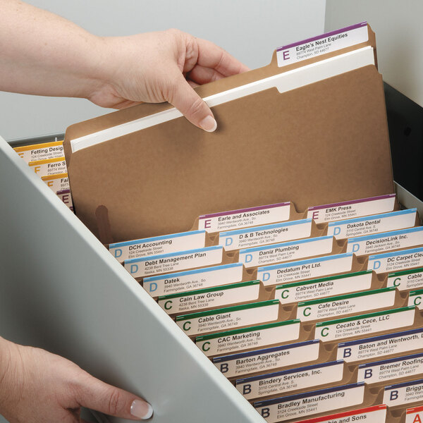 A person taking a file out of a drawer using a Smead Letter Size Fastener Folder.
