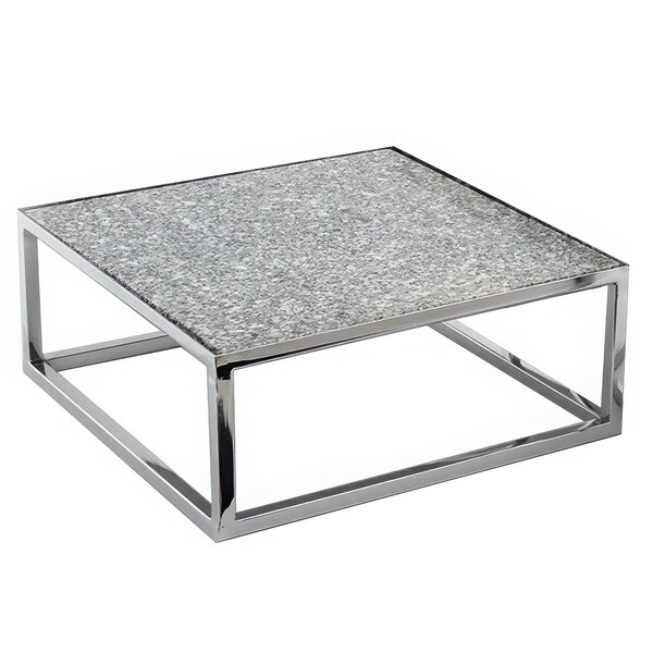 A Clipper Mill square chrome plated iron riser on a table with a marble top.