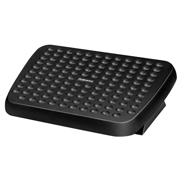 A Fellowes graphite rectangular footrest with holes in the top.