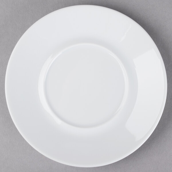 A Schonwald white porcelain saucer with a circular edge on a gray surface.