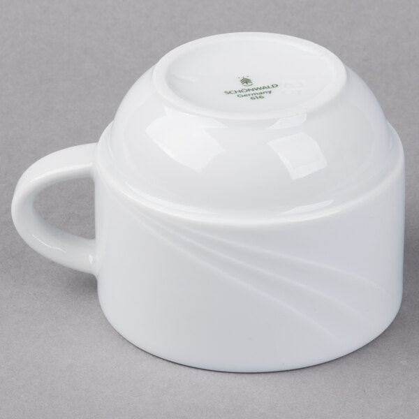 A white Schonwald stacking cup with a handle.