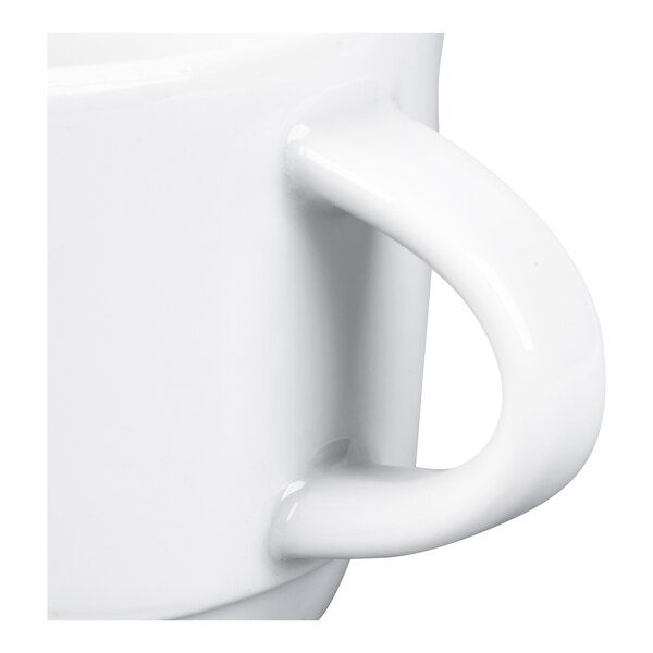 A close-up view of a white ceramic cup handle attached to the side of the cup.