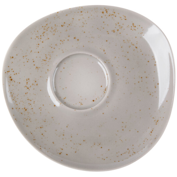 A white Schonwald porcelain saucer with brown speckled spots.