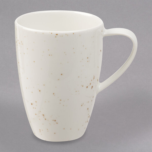 A white Schonwald porcelain mug with brown specks on the handle.