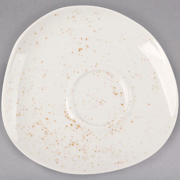 A white Schonwald porcelain saucer with brown speckled spots.