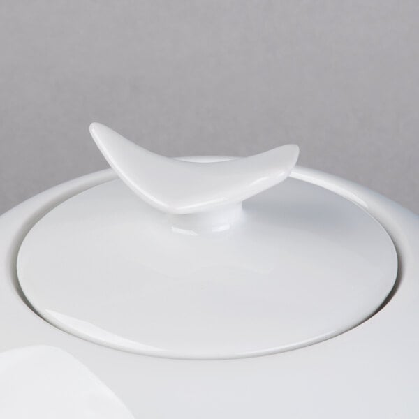 A Schonwald white porcelain teapot with a white lid.