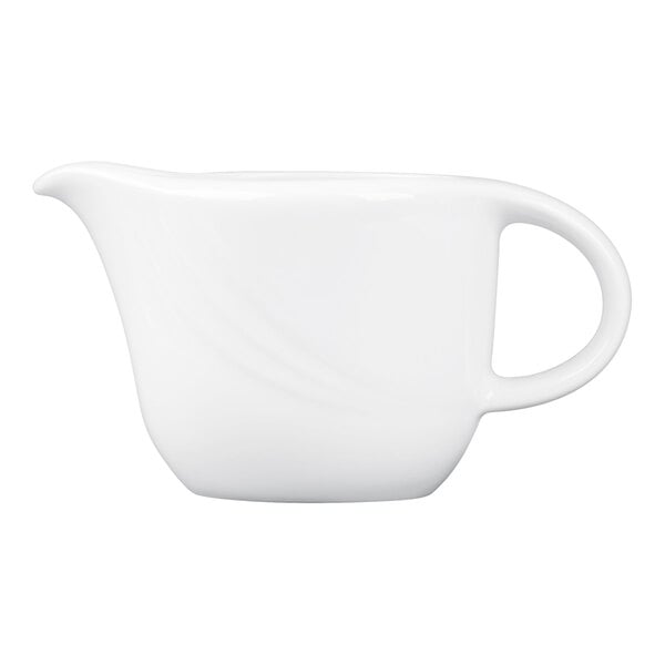 A small white porcelain sauce boat with a handle and a spout.