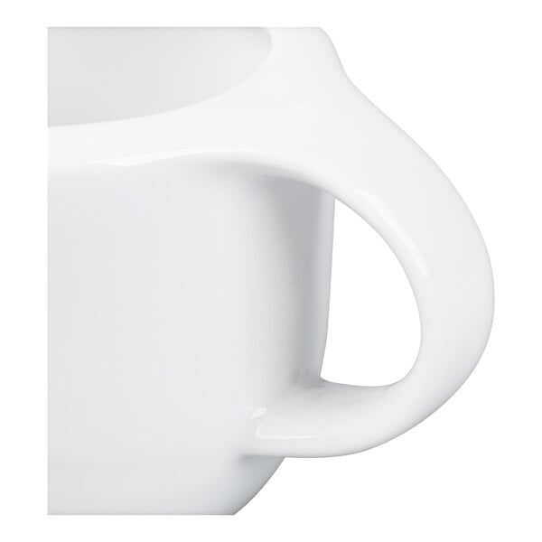 A close-up of a white porcelain cup or sauce boat handle.
