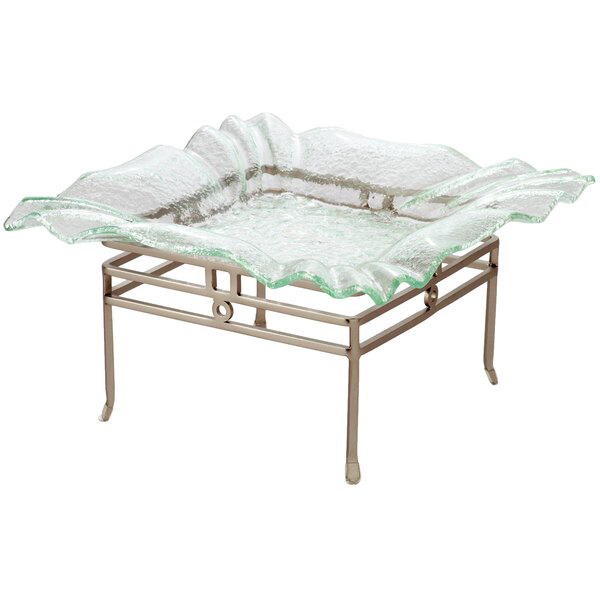 A Clipper Mill chrome powder coated iron square riser with a glass tray on top on a table in a salad bar.