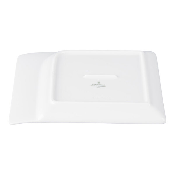 A rectangular white porcelain platter shown upside down with a contoured edge and a manufacturer's mark on the bottom.