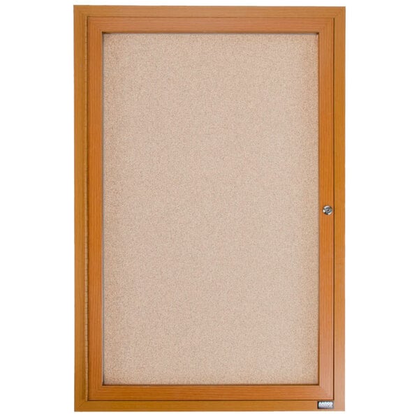 An Aarco enclosed bulletin board with a wooden frame and cork surface.