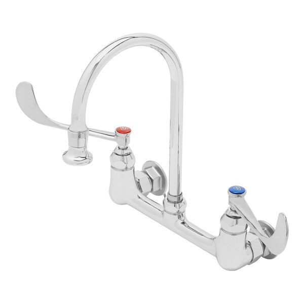 A silver T&S wall mounted surgical sink faucet with wrist action handles.