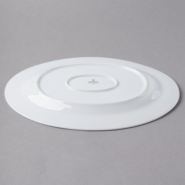 A white Schonwald porcelain platter with a green design of leaves.