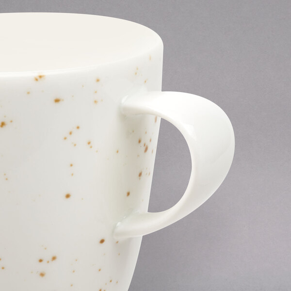 A Schonwald Unique White Porcelain Cup with a speckled design.