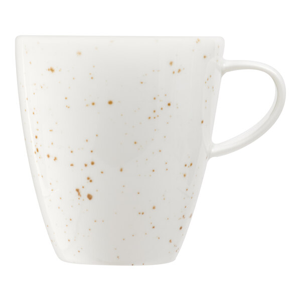 A white porcelain cup with a handle, featuring a pattern of small brown speckles.