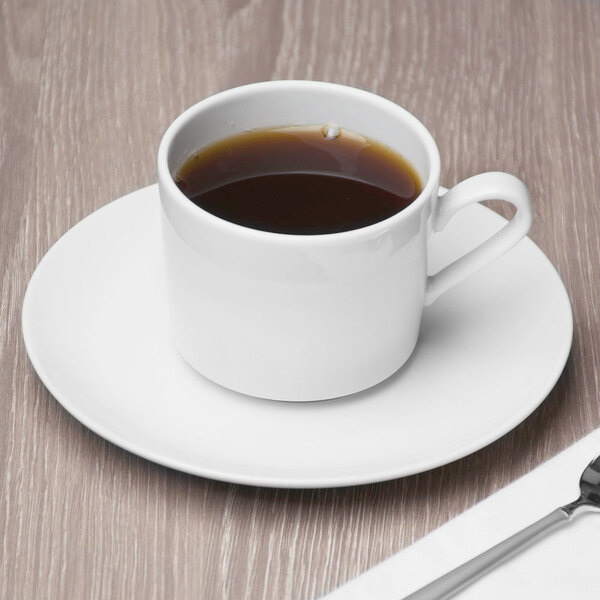 A Schonwald porcelain saucer with a cup of coffee on a table.