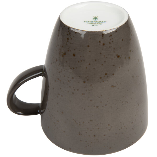A dark gray Schonwald porcelain coffee cup with a handle.