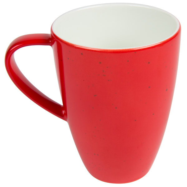 A red and white Schonwald porcelain mug with a speckled design.