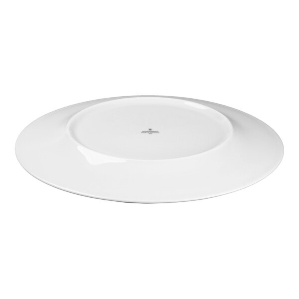 A white, round porcelain plate shown upside down on a white background.