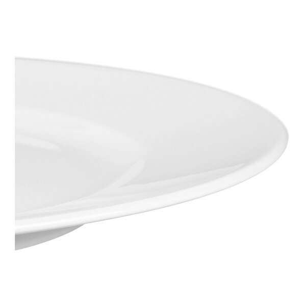A close-up view of the edge of a smooth, white, round plate.