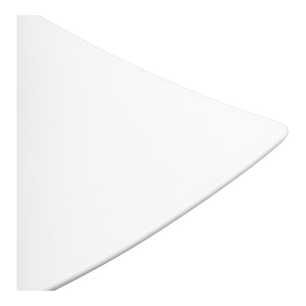 A close-up view of a smooth, white, curved surface, likely part of a plate or dish.