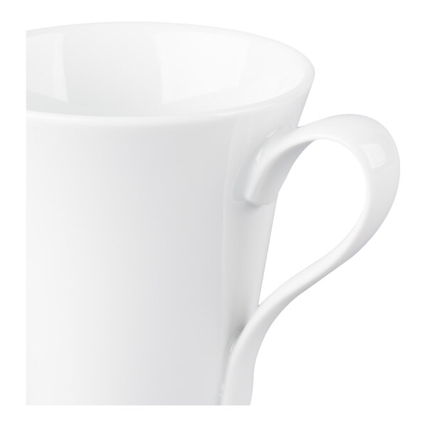 A close-up view of a white porcelain cup with a curved handle.
