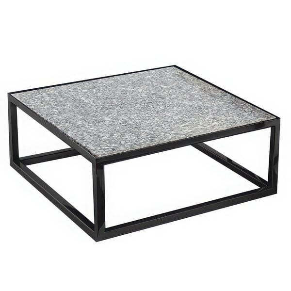 A black powder coated iron square riser on a black and white coffee table.