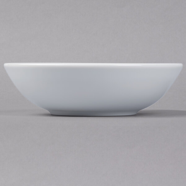 A Schonwald round white porcelain bowl on a white surface.