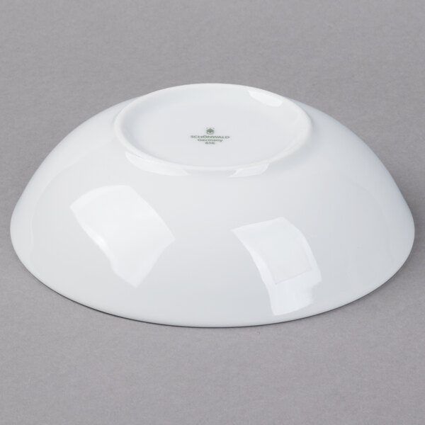 A Schonwald white porcelain bowl on a gray surface.